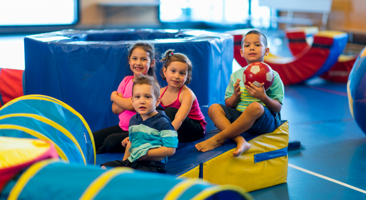 4 toddlers playing in a playground 