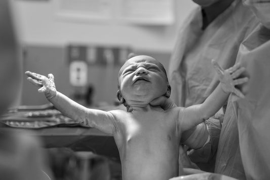 Baby Being Born In Delivery Room