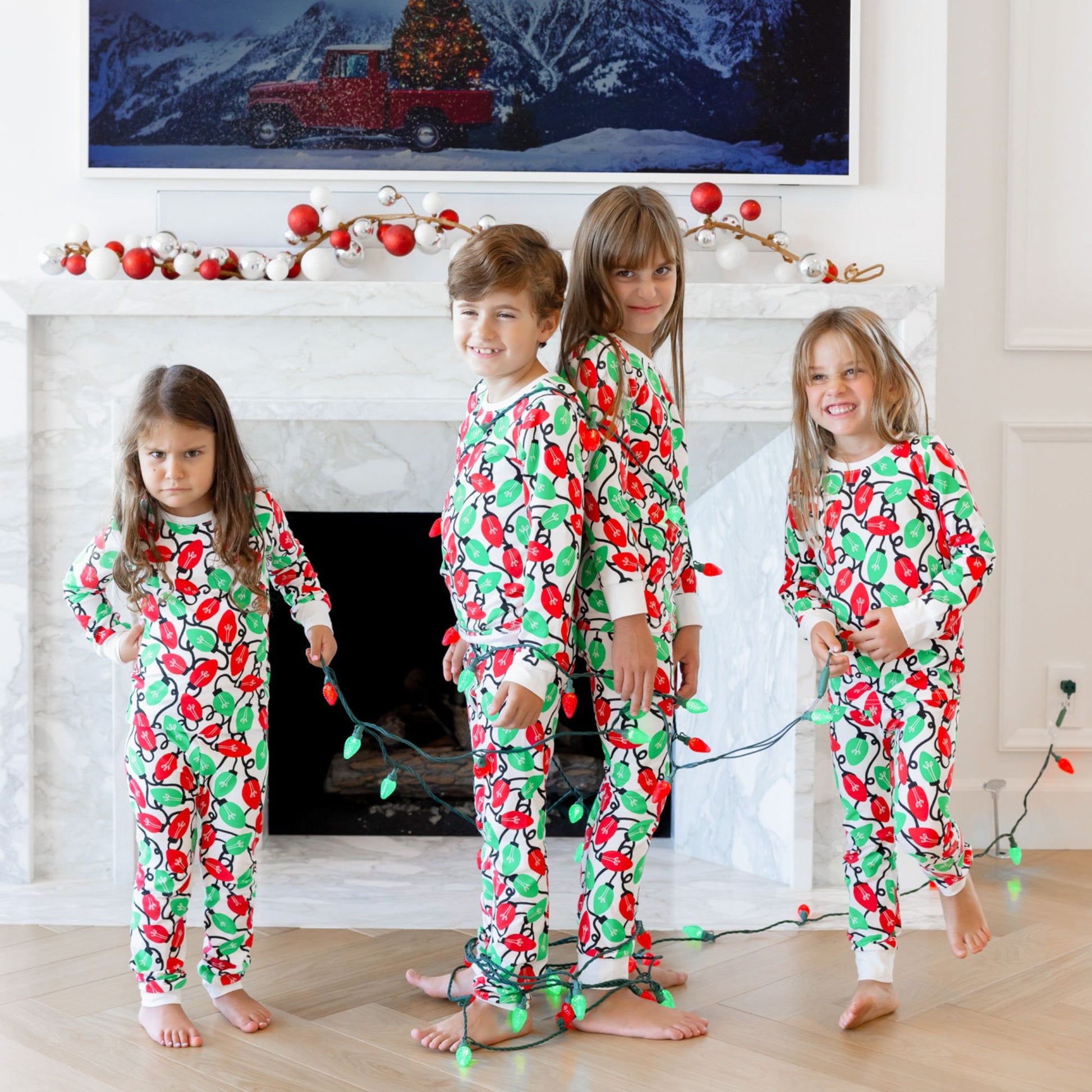 Norani Baby Holiday Pajamas for kids in bright red and green lights
