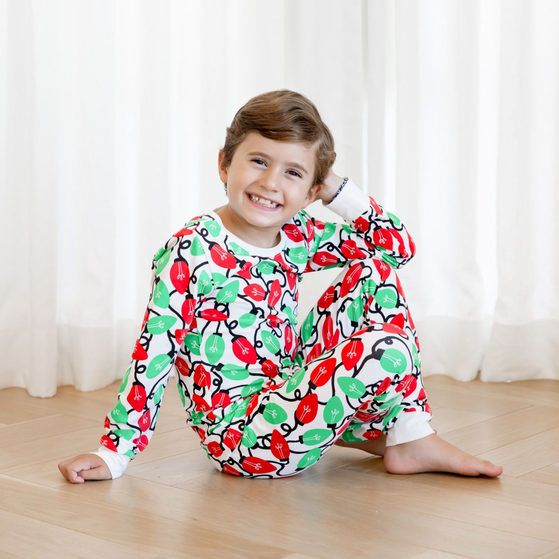 Norani Baby Holiday Pajamas for kids in bright red and green lights
