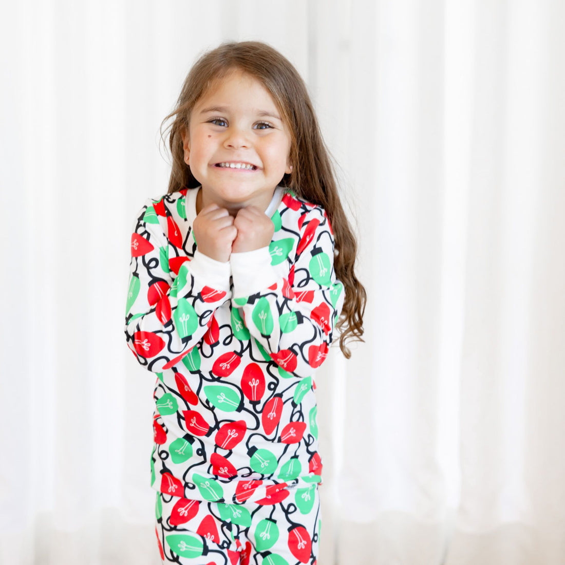 Norani Baby Holiday Pajamas for kids in bright red and green lights
