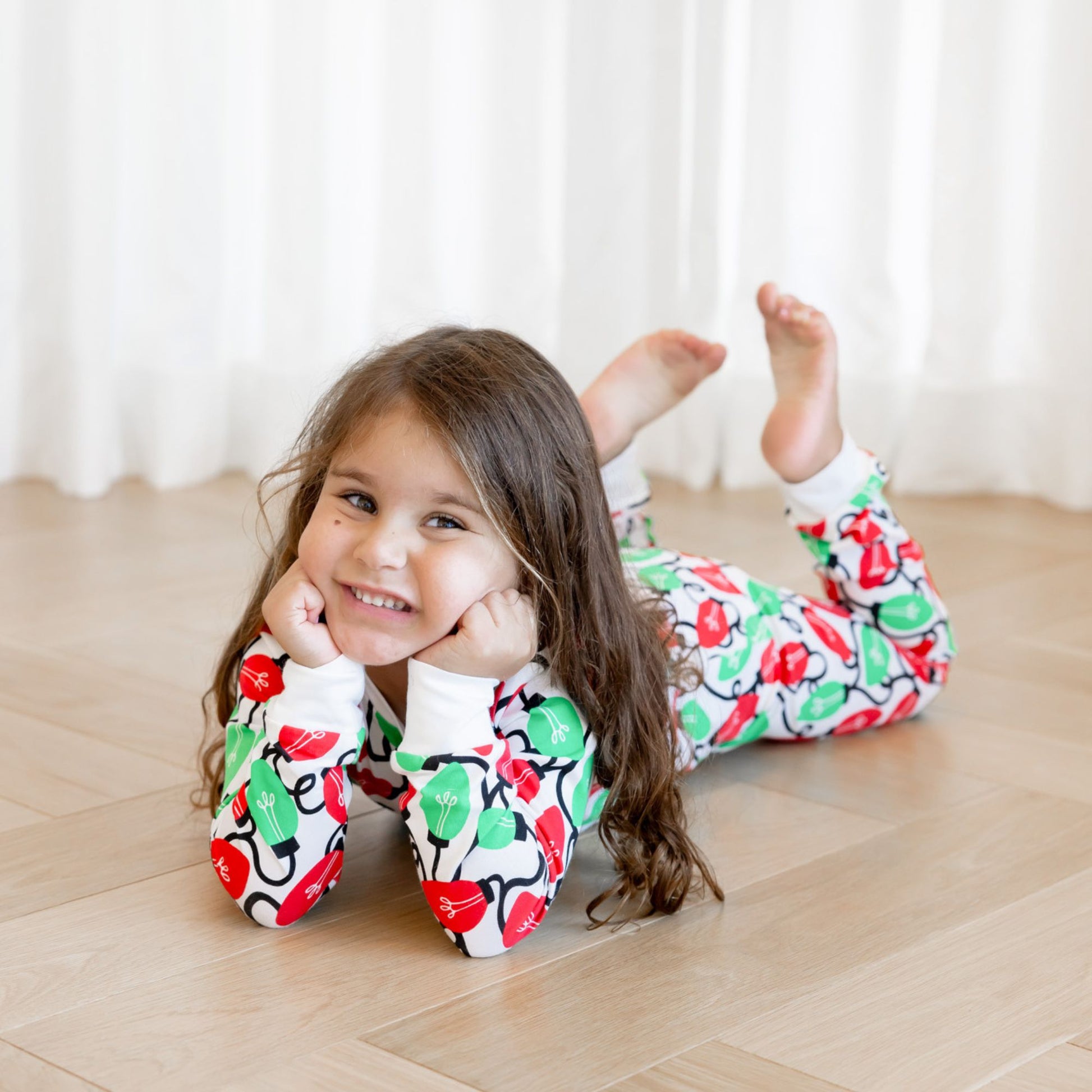 Norani Baby Holiday Pajamas for kids in bright red and green lights
