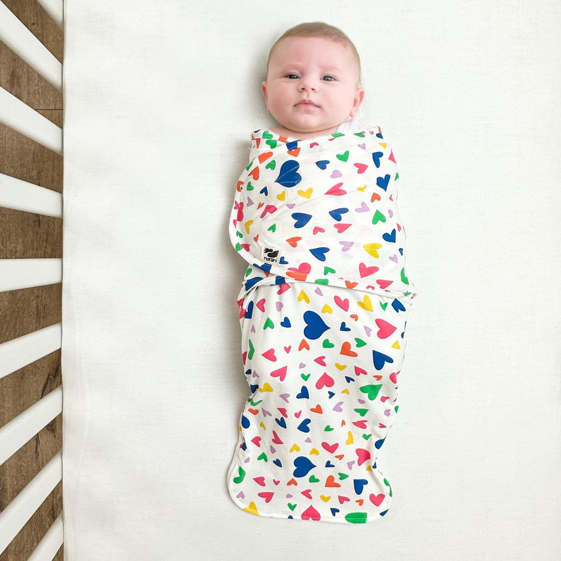 Norani Baby snugababe swaddle pod in colorful hearts