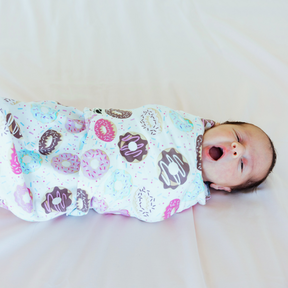 Norani Baby Swaddle Sleep Pod in colorful donuts