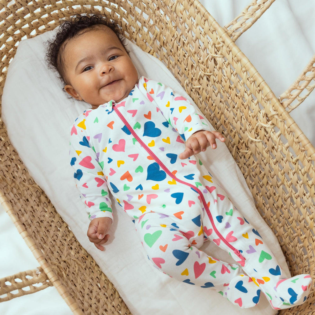 Norani Baby Footed ZIpper Onesie in colorful hearts