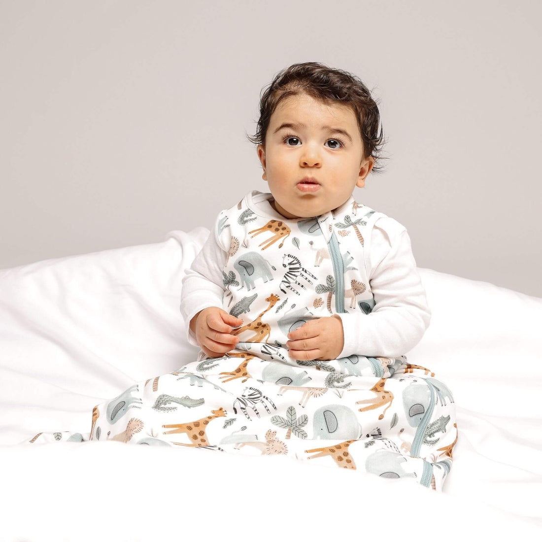 Baby in Norani Baby One & Done Sleep Sack - in Safari animals