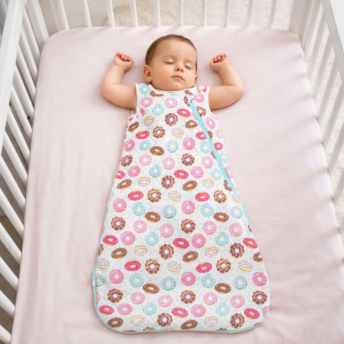 Baby sleeping peacefully in the Norani Baby One & Done Sleep Sack, featuring soft GOTS-certified organic cotton, a cozy all-season design, and a secure zip closure for safe sleep.