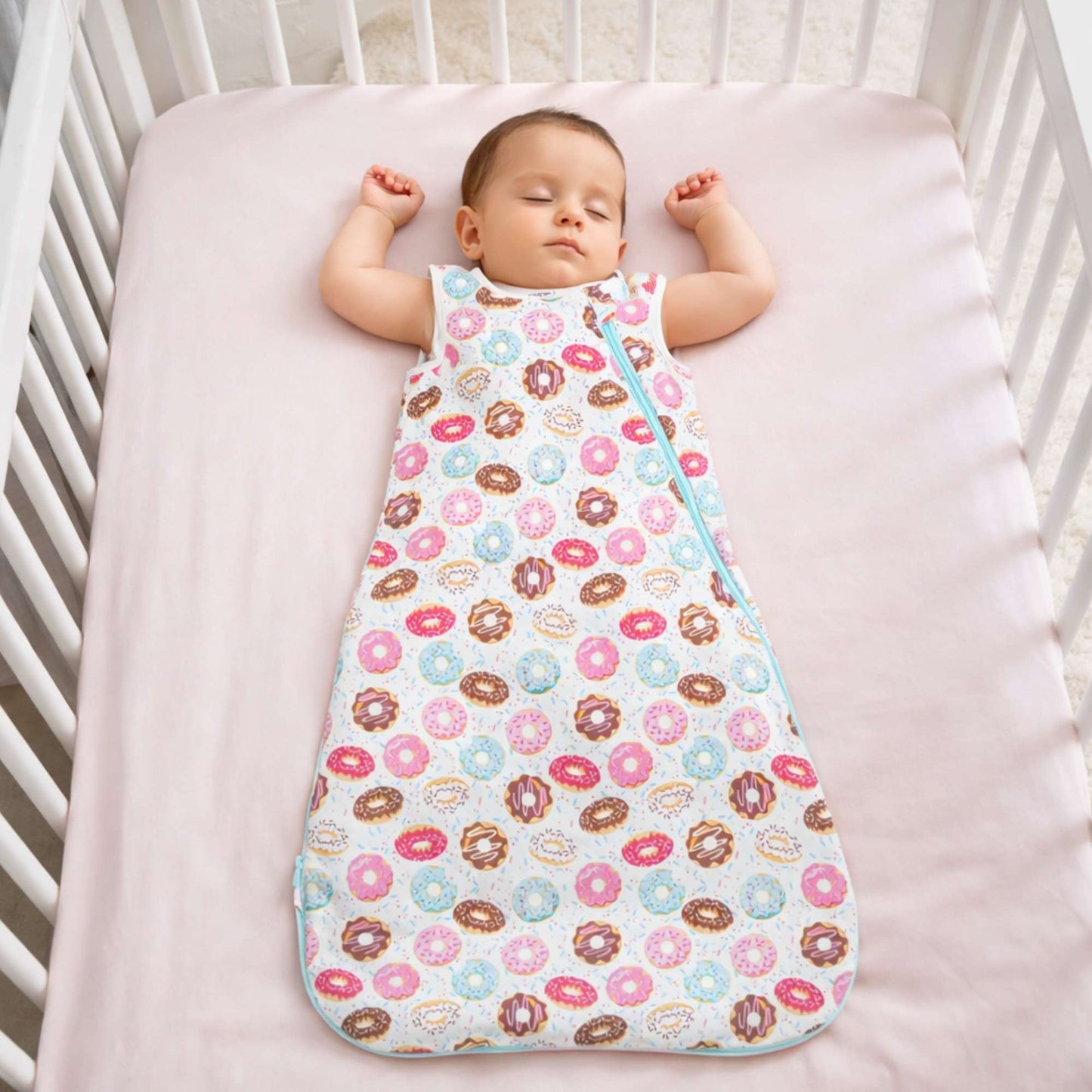 Baby sleeping peacefully in the Norani Baby One & Done Sleep Sack, featuring soft GOTS-certified organic cotton, a cozy all-season design, and a secure zip closure for safe sleep.