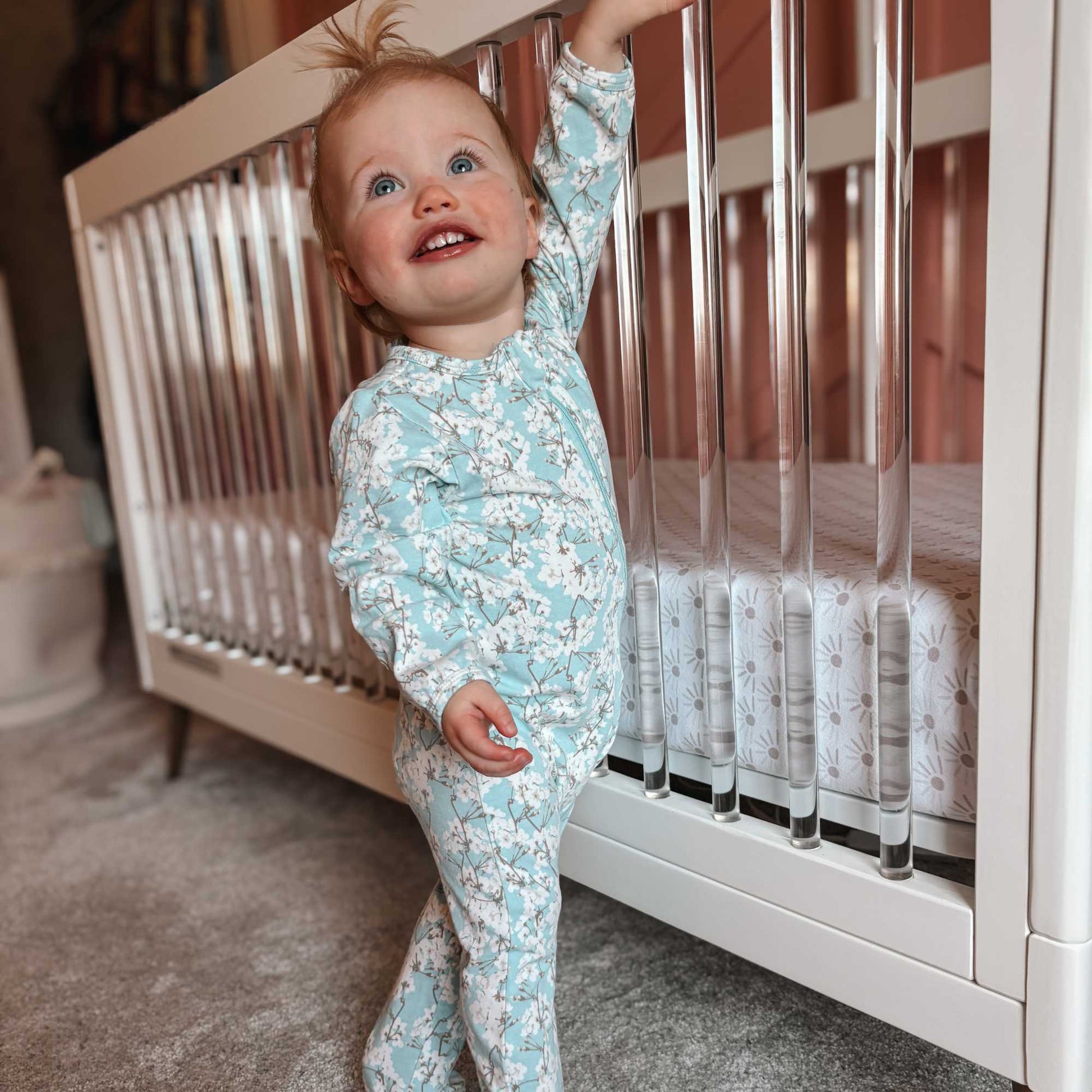 Norani Baby footed zippered onesie in blue and white cherry blossom flowers