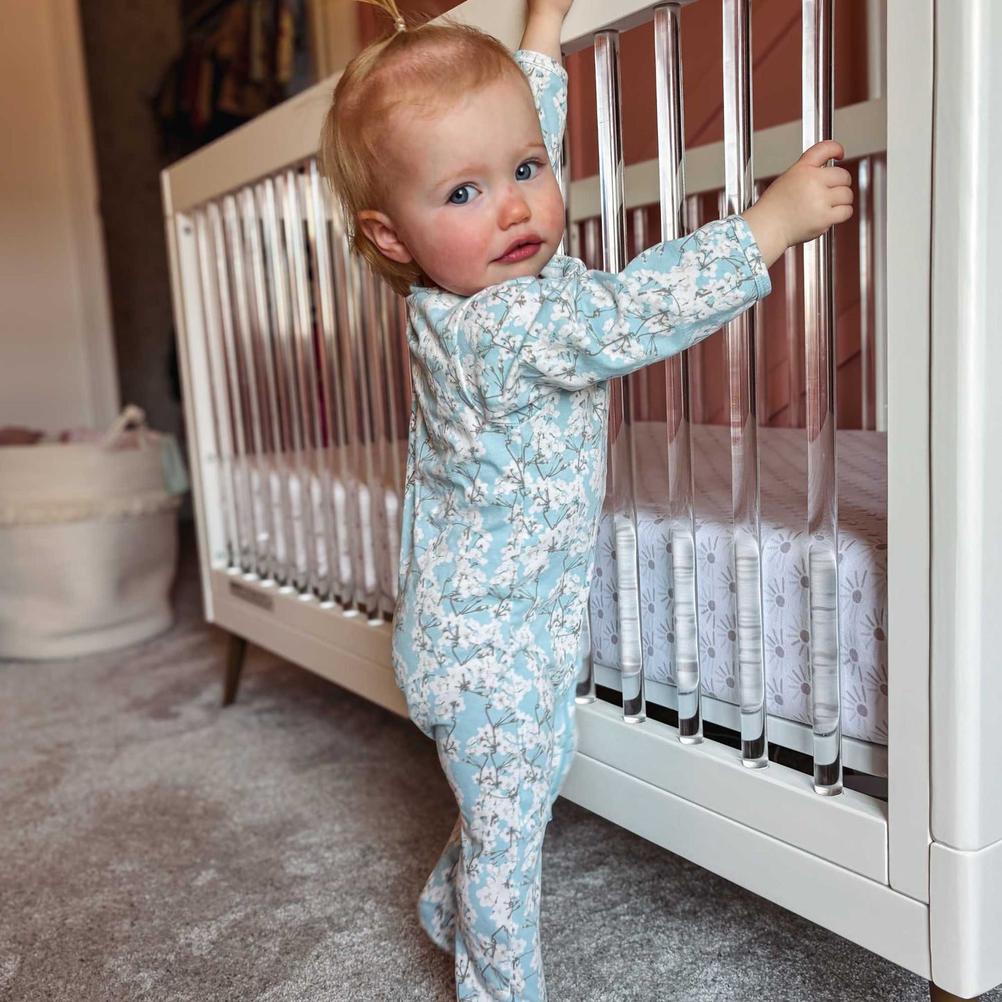 Norani Baby footed zippered onesie in blue and white cherry blossom flowers