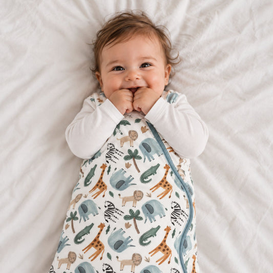 baby smiling at camera in the norani baby sleep sack