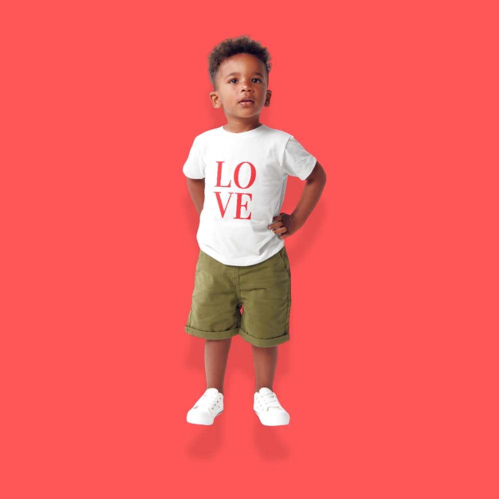 Child wearing a white t-shirt with 'LOVE' printed in red on a red background