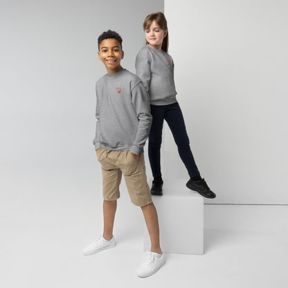 Girl and boy standing together wearing matching gray crewneck sweatshirts with a subtle embroidered heart on the chest, styled casually for a cozy, everyday look.